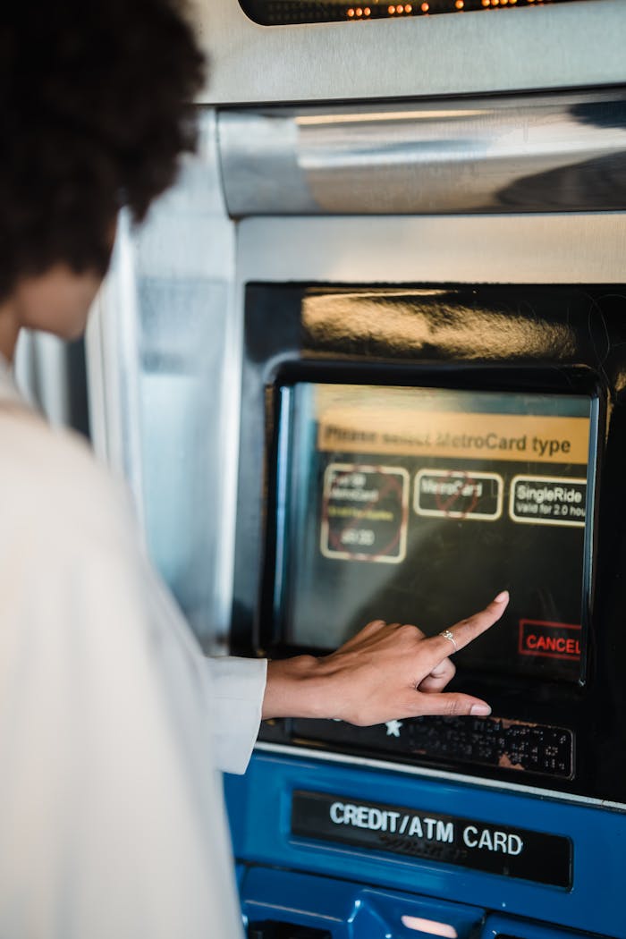 Close-up of a woman selecting MetroCard options at a vending machine.